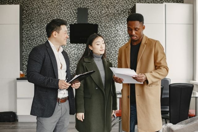 three people reviewing documents