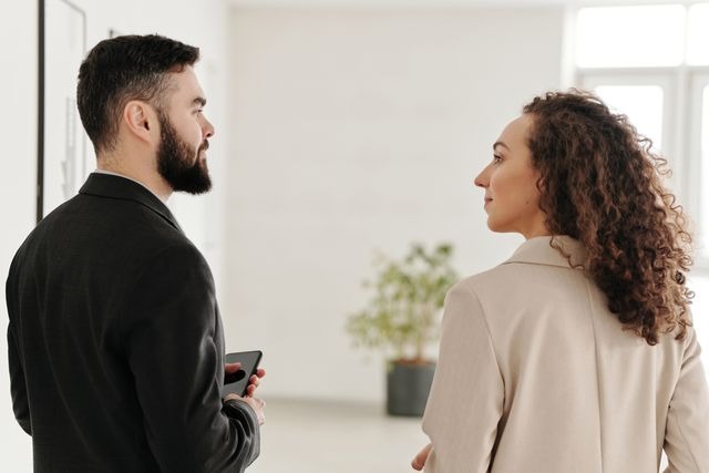 two people looking at each other inside