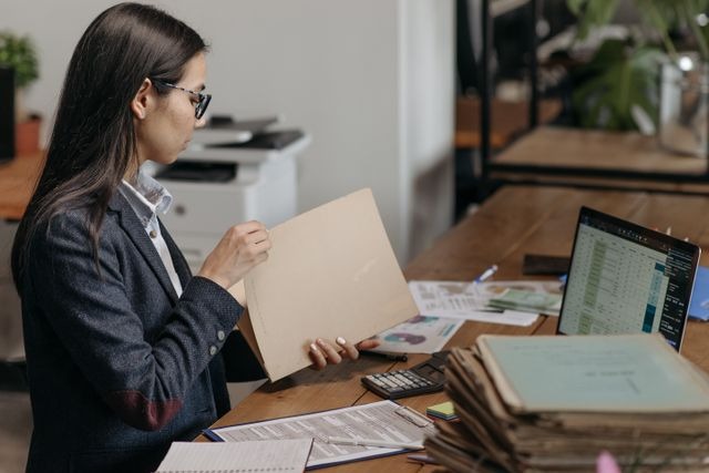 a person reviewing documents at a desk