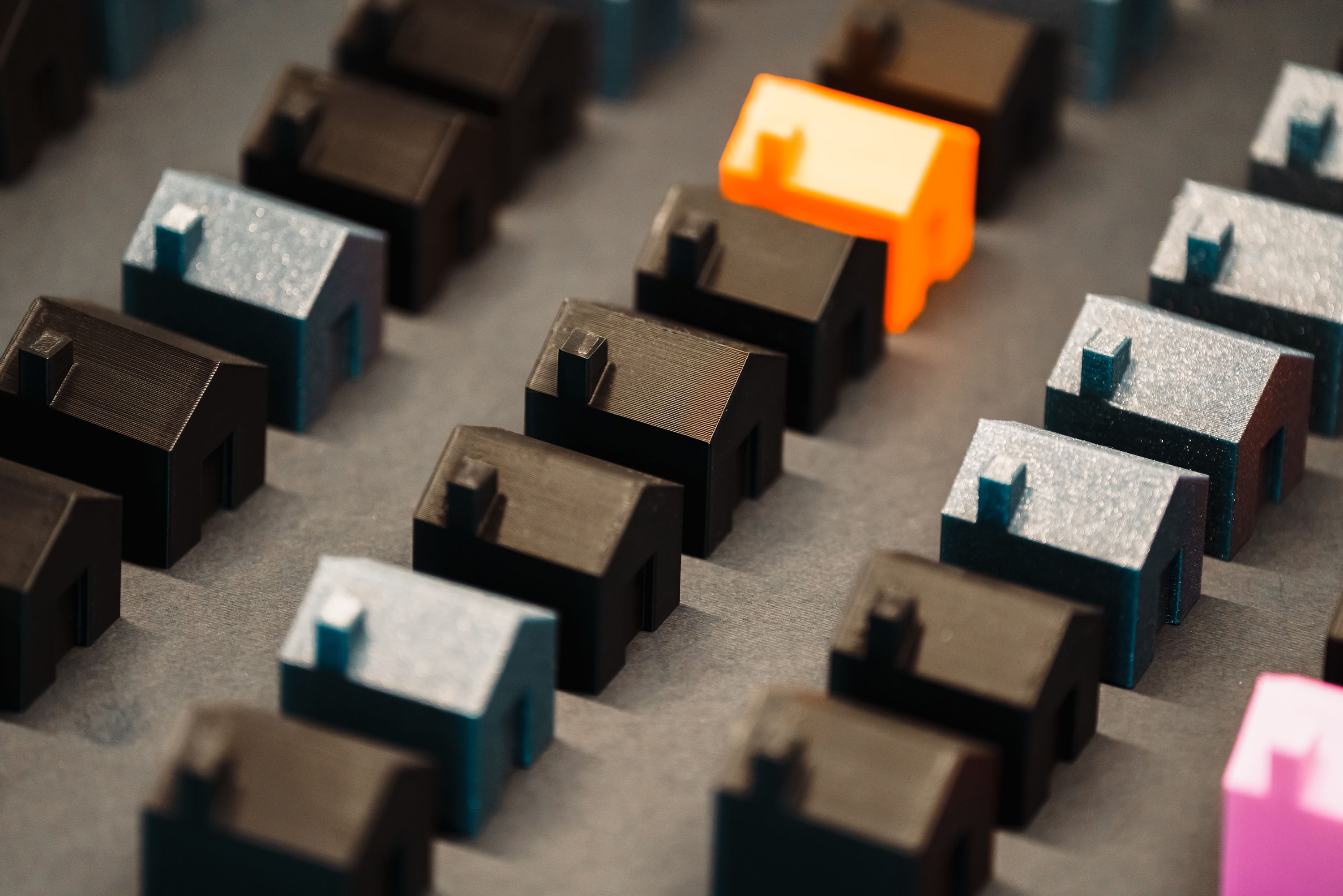 Rows of little black gray pink and orange model houses